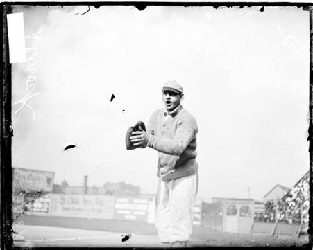 Baseball player Nick Altrock, Chicago White Sox, touching his baseball glove with the palm of his left hand - Chicago Daily News, Inc.
