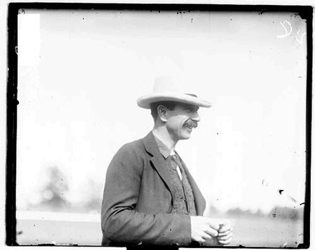 Polo player Foxhall P. Keene standing outdoors - Chicago Daily News, Inc.
