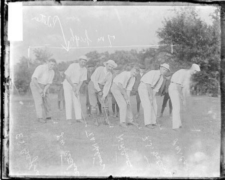 Golfers Castle, Pitcher, Curtis, Helmer, Taylor, and Watson holding putters or wedge golf clubs and addressing golf balls - Chicago Daily News, Inc.