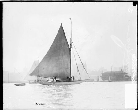 Yacht Vannena lying at anchor in a body of water, crew members are standing on the deck of the boat - Chicago Daily News, Inc.