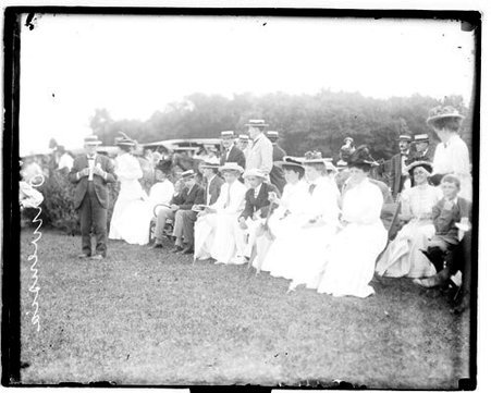 Spectators sitting and standing on a lawn at Onwentsia Club - Chicago Daily News, Inc.