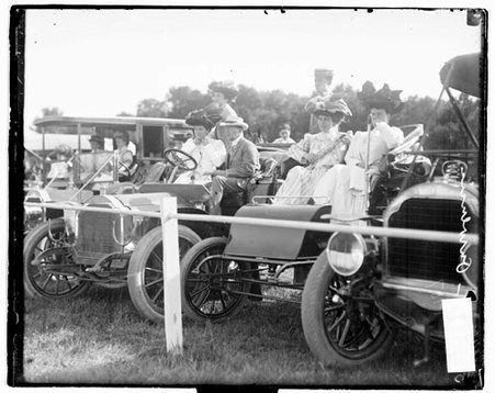 Women and men sitting in automobiles parked near a polo field at Onwentsia Club - Chicago Daily News, Inc.