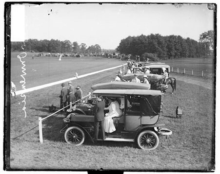 Spectators sitting in and standing in front of automobiles at Onwentsia Club - Chicago Daily News, Inc.