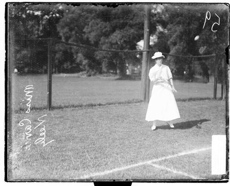 Tennis player Carrie Neely holding a tennis racket and following through after hitting a tennis ball - Chicago Daily News, Inc.