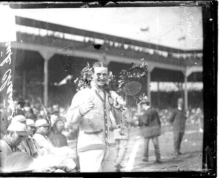 Baseball player Frank Chance, Chicago Cubs, holding a floral arrangement, on the field during the 1907 World Series - Chicago Daily News, Inc.