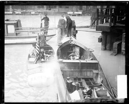 Yacht Lizzie S. and motorboat Bereda sitting side by side in a body of water - Chicago Daily News, Inc.