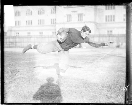 University of Chicago football player J. Doseff holding a football with his right hand - Chicago Daily News, Inc.