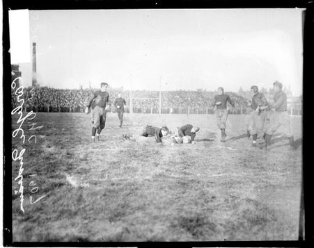 Carlisle Indians and the University of Chicago game, two football players lying sprawled on the ground on an athletic field - Chicago Daily News, Inc.