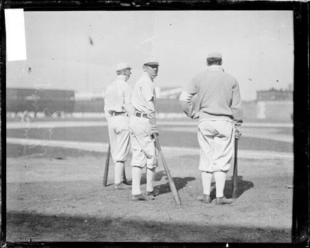 Baseball player Jiggs Donahue, Chicago White Sox, leaning against a baseball bat that he is holding - Chicago Daily News, Inc.