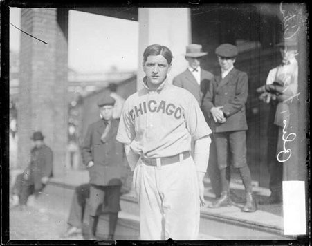 Baseball player Frank Olis, Chicago Cubs, standing in front of a building - Chicago Daily News, Inc.
