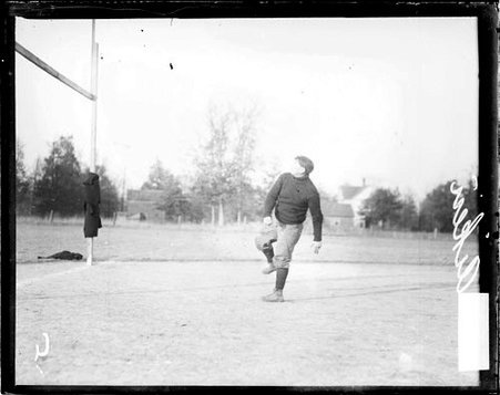Carlisle Indians football player Aiken following through after throwing a football, standing on one foot - Chicago Daily News, Inc.