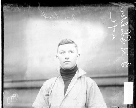 University of Chicago baseball player G. H. Sheldon looking to his left, standing in front of a building - Chicago Daily News, Inc.
