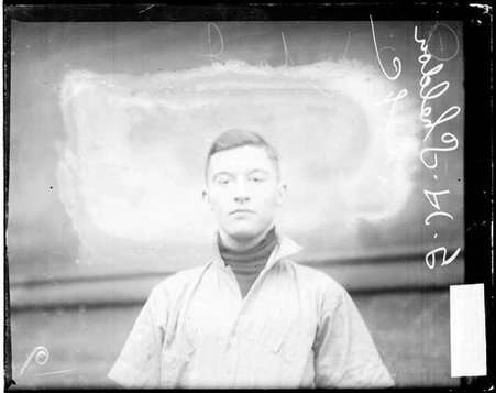 University of Chicago baseball player G. H. Sheldon looking at the camera, standing in front of a building - Chicago Daily News, Inc.