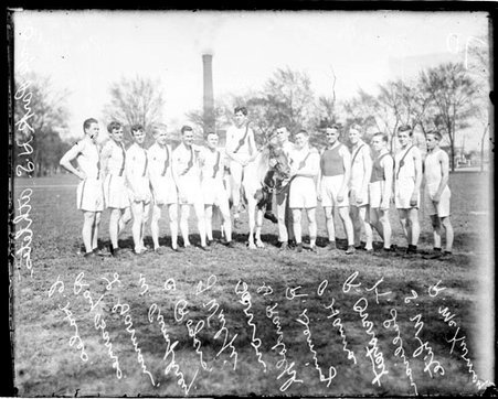 Oak Park High School athletes standing in a row on a field , a runner is sitting atop a horse in the middle of the row - Chicago Daily News, Inc.