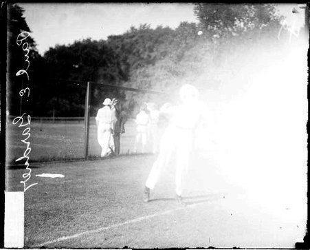 Tennis player Paul E. Gardener cocking his harm to hit a tennis ball - Chicago Daily News, Inc.