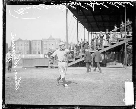 Wendell Phillips High School baseball player Charles Wayman following through after throwing a baseball - Chicago Daily News, Inc.