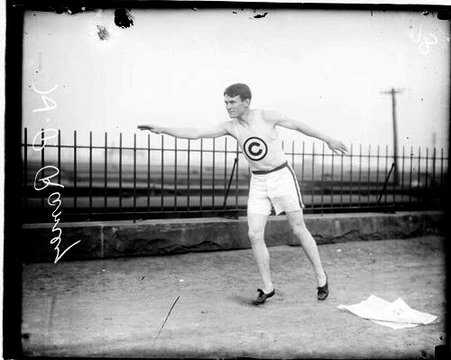 Athlete H. P. Ramey holding his right arm in front of him and his left arm behind him - Chicago Daily News, Inc.