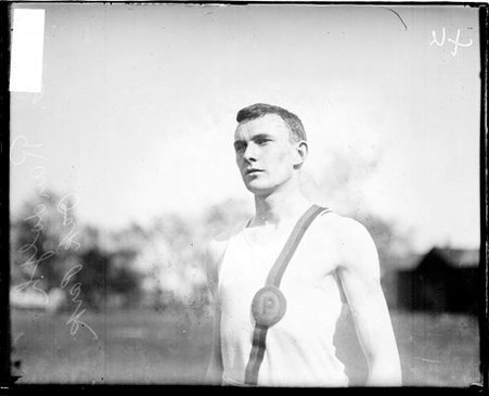 Oak Park runner G. Randolph standing on a field - Chicago Daily News, Inc.