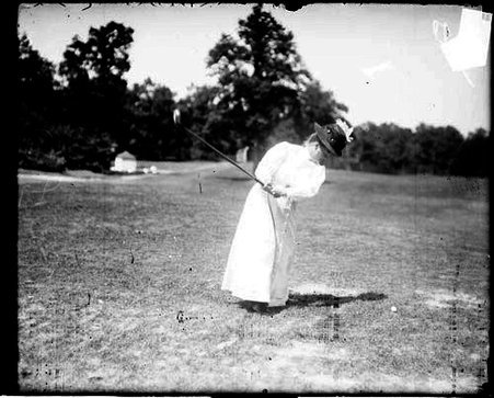 Golfer Mrs. C. F. Braffette swinging back a golf club, standing on the grounds of an unidentified golf course - Chicago Daily News, Inc.