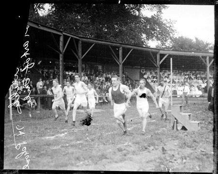 Group of athletes racing on an athletic track - Chicago Daily News, Inc.