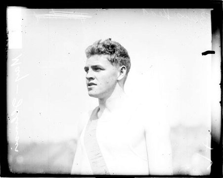 Runner W. W. May standing on an athletic field - Chicago Daily News, Inc.