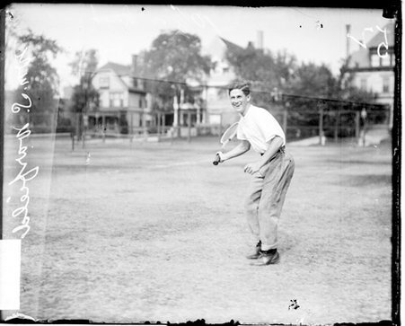 Tennis player W. S. Warfield holding a tennis racket and drawing his arm back - Chicago Daily News, Inc.