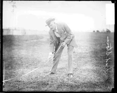 C. A. .A (Chicago Athletic Association) track team coach F. W. Stone holding a tape measure extended on the ground - Chicago Daily News, Inc.