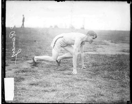 C. A. .A (Chicago Athletic Association) athlete H. P. Ramey crouching in an athletic position on an athletic field - Chicago Daily News, Inc.