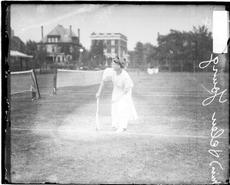 Tennis player Helen Young following through after swinging a tennis racket - Chicago Daily News, Inc.