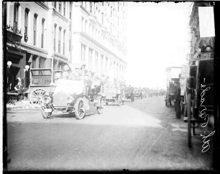 Illinois Athletic Club automobiles driving in a line on a street, during a parade - Chicago Daily News, Inc.