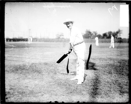 Cricket player Dr. Murray of St. Louis, holding a cricket bat, standing in a batting stance - Chicago Daily News, Inc.