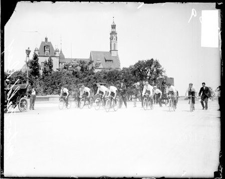 Group of boys and young men riding bicycles on a wide street on Motor Field Day - Chicago Daily News, Inc.