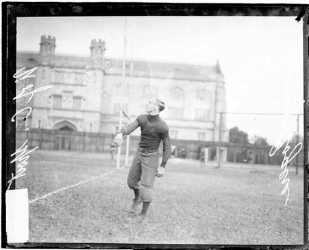 University of Chicago football player Bunny Rogers following through after throwing a football - Chicago Daily News, Inc.