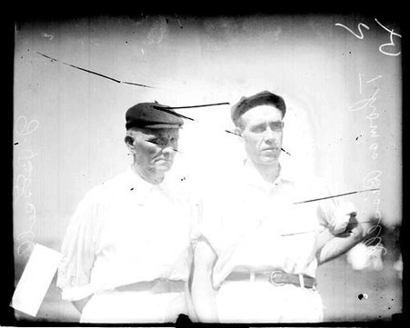 Cricket players Thomas Bissell and J. Bissell standing outdoors - Chicago Daily News, Inc.