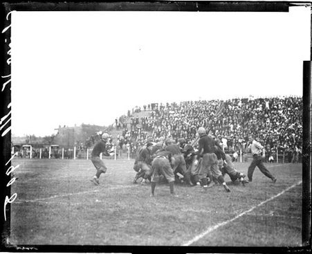 University of Chicago and Illinois football players crowding in a tackle at Marshall Field - Chicago Daily News, Inc.