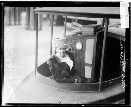 Mrs. Pearson, mother of Ralph M. Pearson, sitting in a boat in a body of water - Chicago Daily News, Inc.