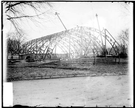 Frame of a new gymansium on the Northwestern University campus viewed at an angle from a dirt road in front of the construction site - Chicago Daily News, Inc.