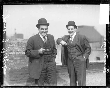 Boxer, James J. Jeffries looking at the camera, standing with Sam Berger on the roof of a building - Chicago Daily News, Inc.