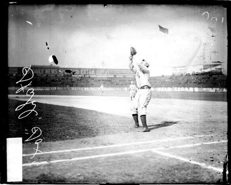 Baseball player Stahl, Chicago White Sox, looking up and holding his gloved hand in the air to catch a fly ball - Chicago Daily News, Inc.