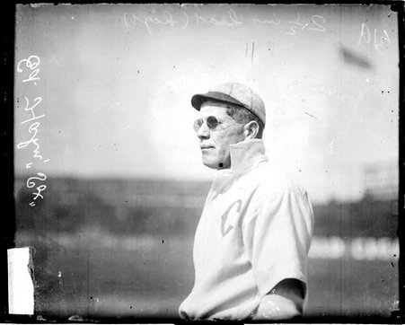 Baseball player Ed Hahn, Chicago White Sox, wearing sunglasses, standing on the field at South Side Park - Chicago Daily News, Inc.