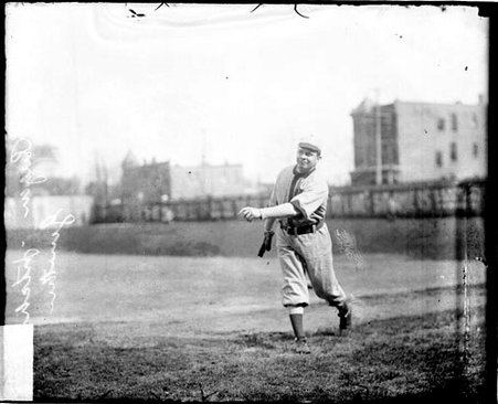 Pitcher Ed Rugan, Gunther, following through after throwing a baseball, standing on a baseball field - Chicago Daily News, Inc.