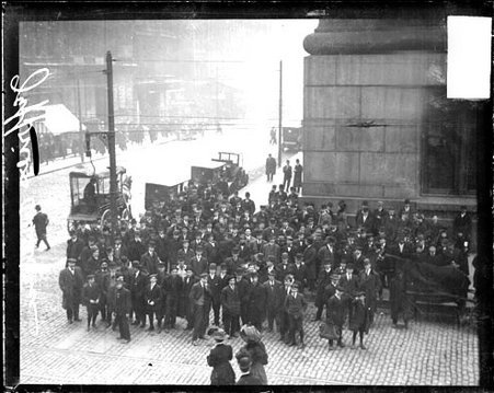 Crowds standing on the corner of a street in front of a building during an appearance by boxer James J. Jeffries - Chicago Daily News, Inc.