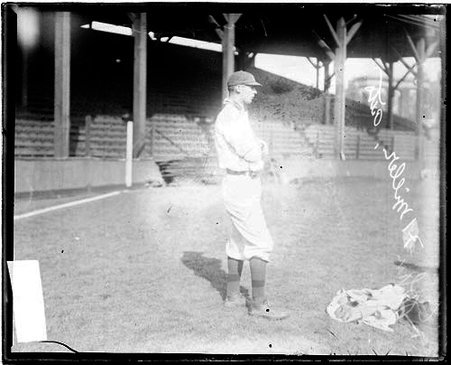 Baseball player Jack Miller, Pittsburgh, standing in profile in front of grandstands - Chicago Daily News, Inc.