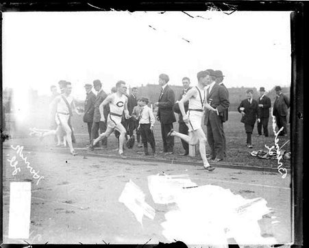 Athletes Bresnehan, Comstock of the University of Chicago, and Herrick of Illinois, racing on the track at Marshall Field - Chicago Daily News, Inc.