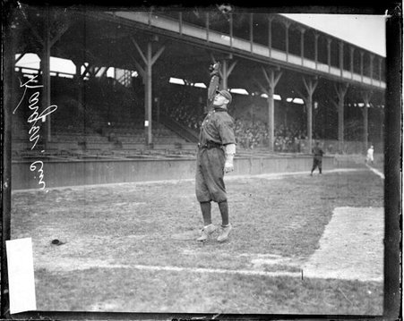 Baseball player Karger, Cincinnati, reaching up with his gloved right hand to catch a baseball - Chicago Daily News, Inc.