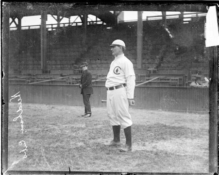 Baseball player Pat Moran, Chicago Cubs, standing in front of grandstands on the field at West Side Grounds - Chicago Daily News, Inc.