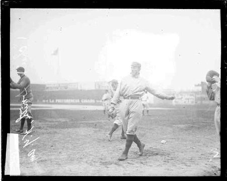 Baseball player Charles Smith, New York, holding his left arm straight behind him, at South Side Park - Chicago Daily News, Inc.