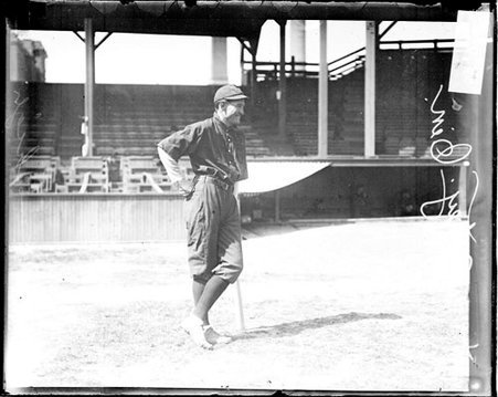 Baseball player Autrey, Cincinnati, leaning on a baseball bat in front of bleachers - Chicago Daily News, Inc.