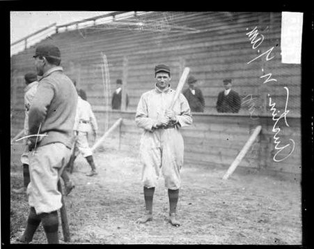 Baseball player Austin, New York, holding a baseball bat over his shoulder - Chicago Daily News, Inc.
