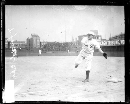 Baseball player Del Howard, Chicago Cubs, following through after throwing a baseball - Chicago Daily News, Inc.